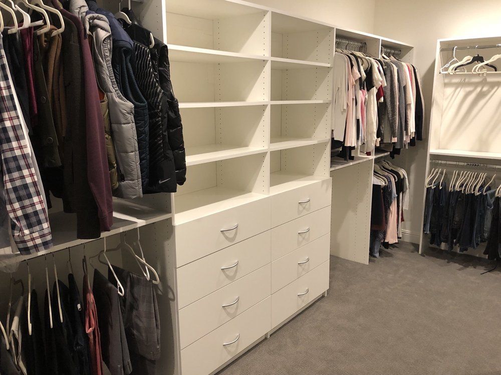 White executive walk-in closet system with drawers and shelving