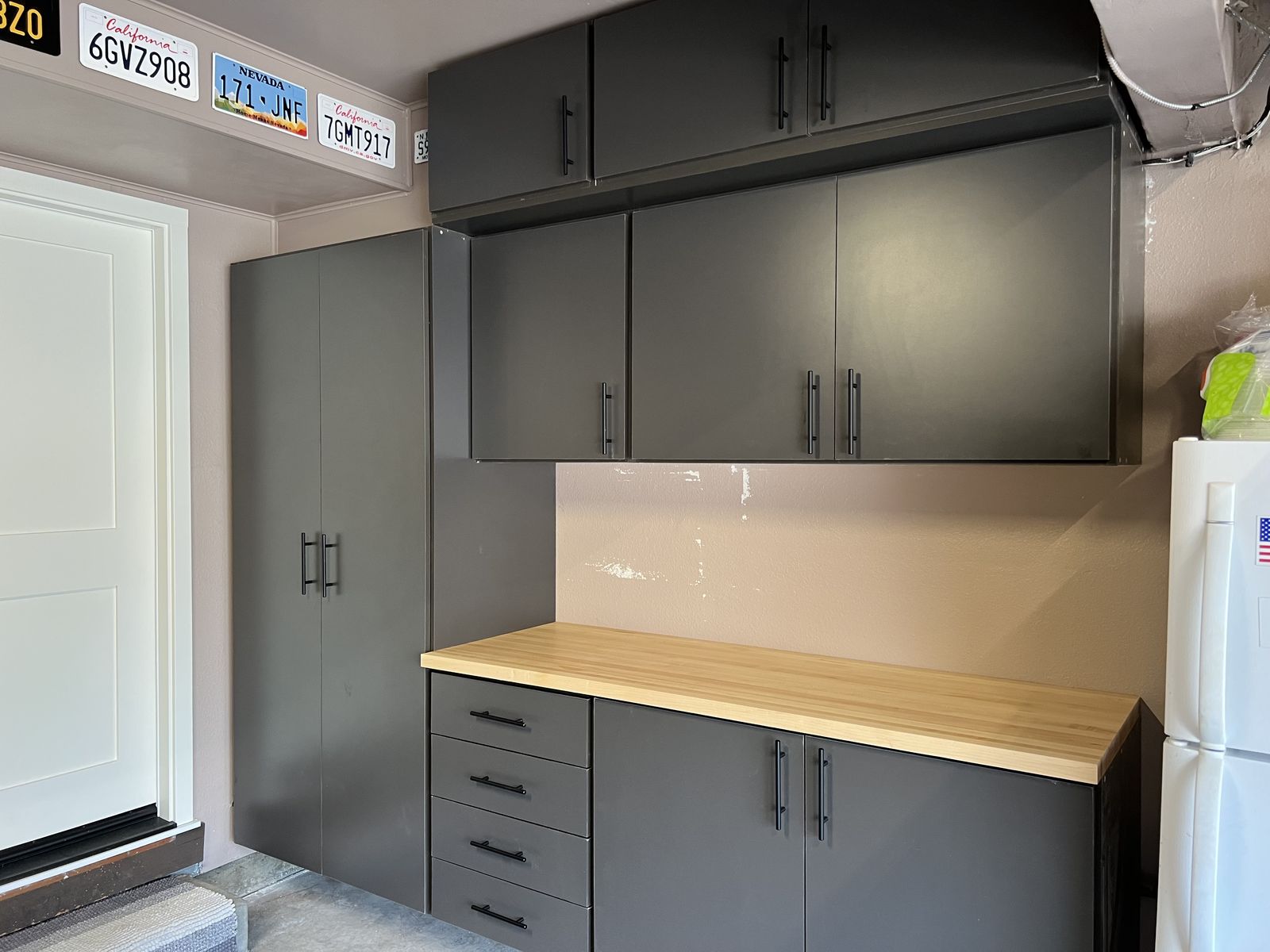 Charcoal garage cabinets with wood countertop