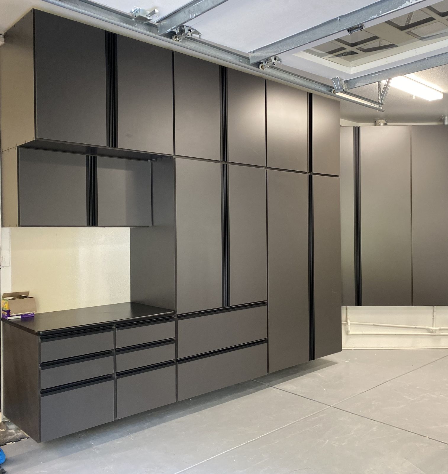 Charcoal garage cabinet wall with workbench