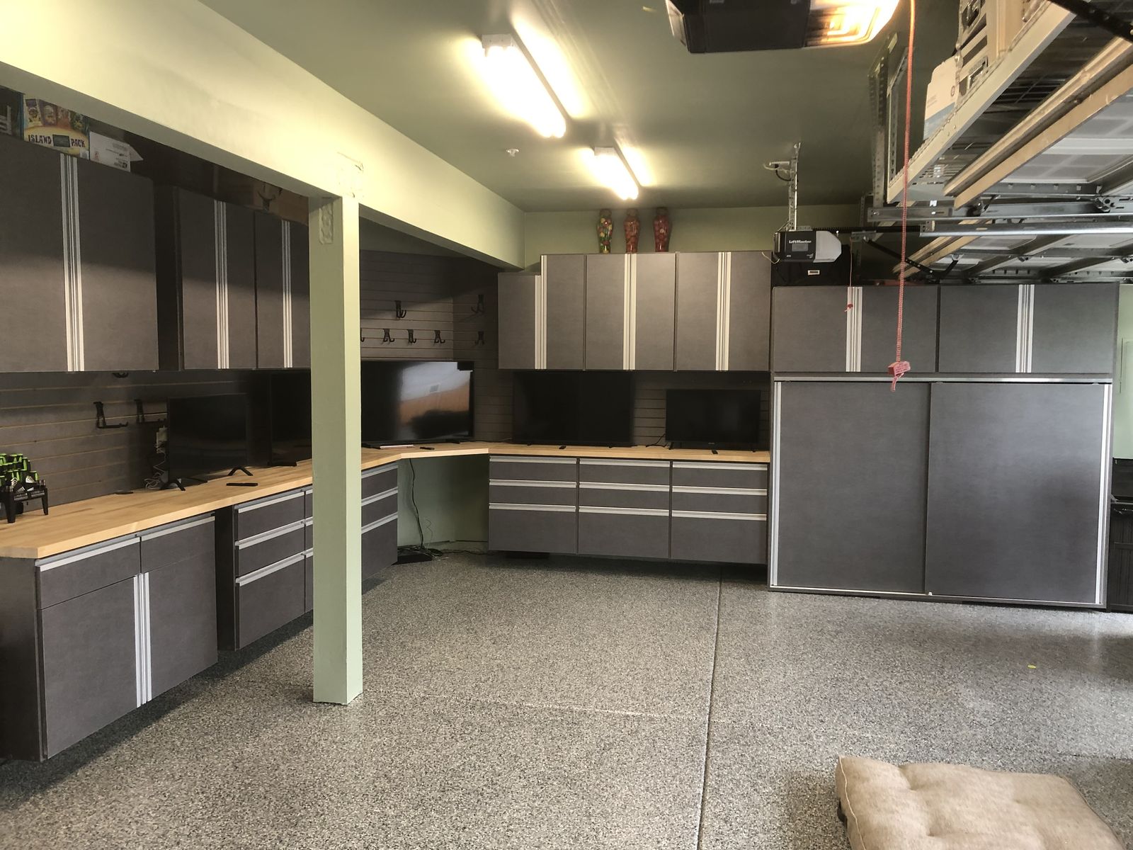 Full garage makeover with cabinet run, workbench, and chip floor
